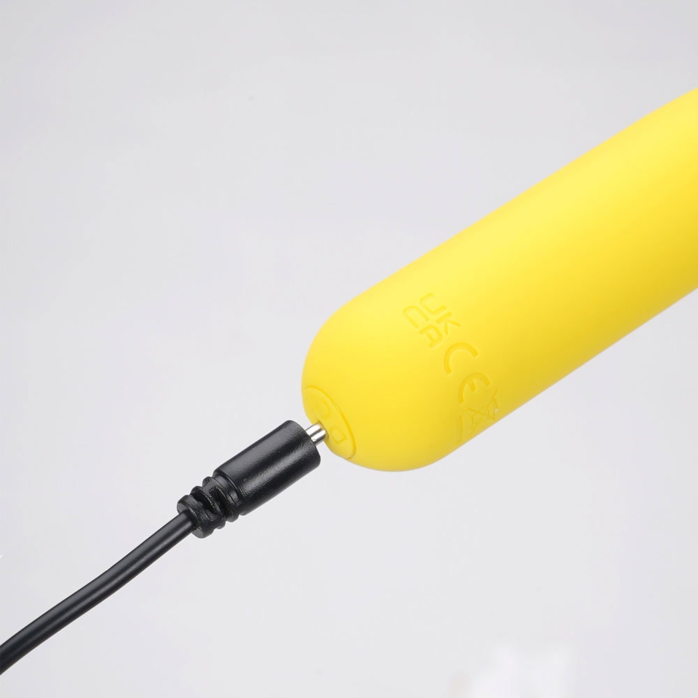 Maia Tawni yellow flickering bullet vibrator, compact silicone design with charging cable