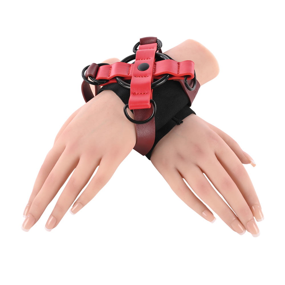 Sportsheets Exs & Ohs Cross Cuffs, an X-shaped wrist restraint with adjustable straps and D-ring fastening