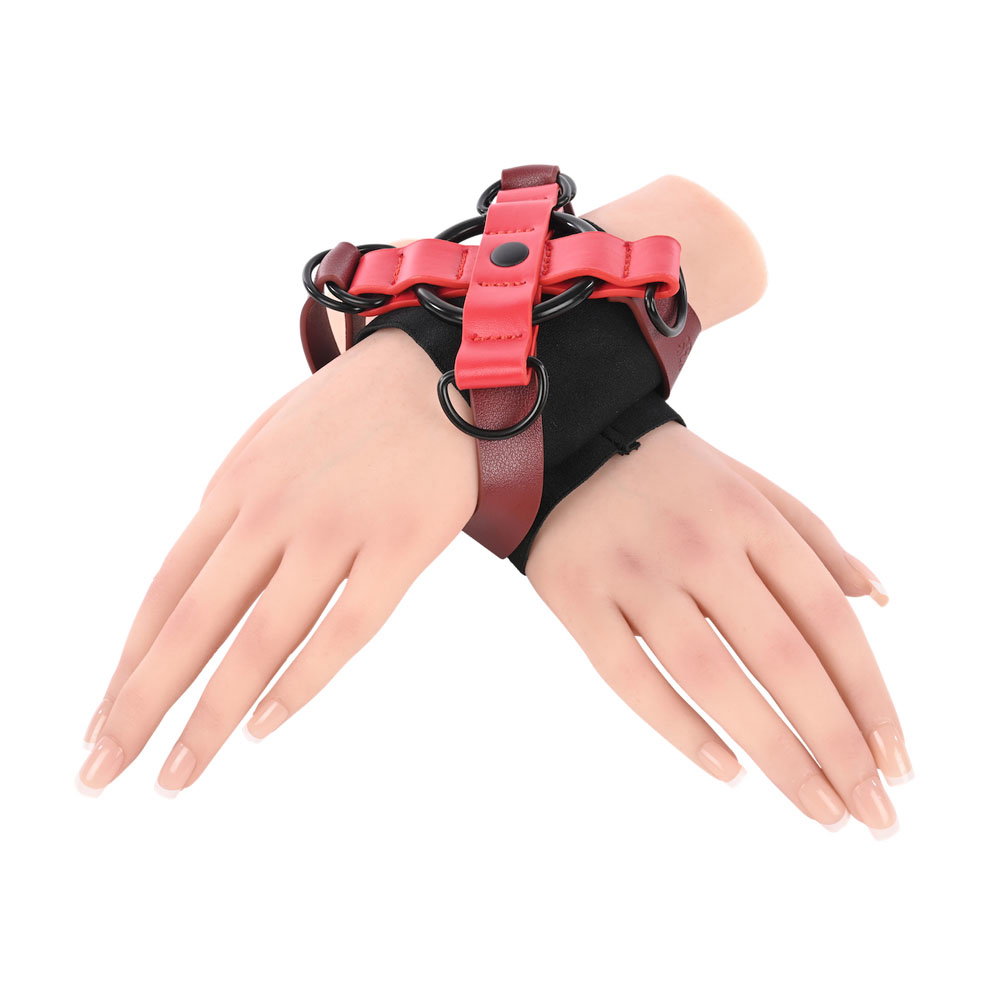 Sportsheets Exs & Ohs Cross Cuffs, an X-shaped wrist restraint with adjustable straps and D-ring fastening