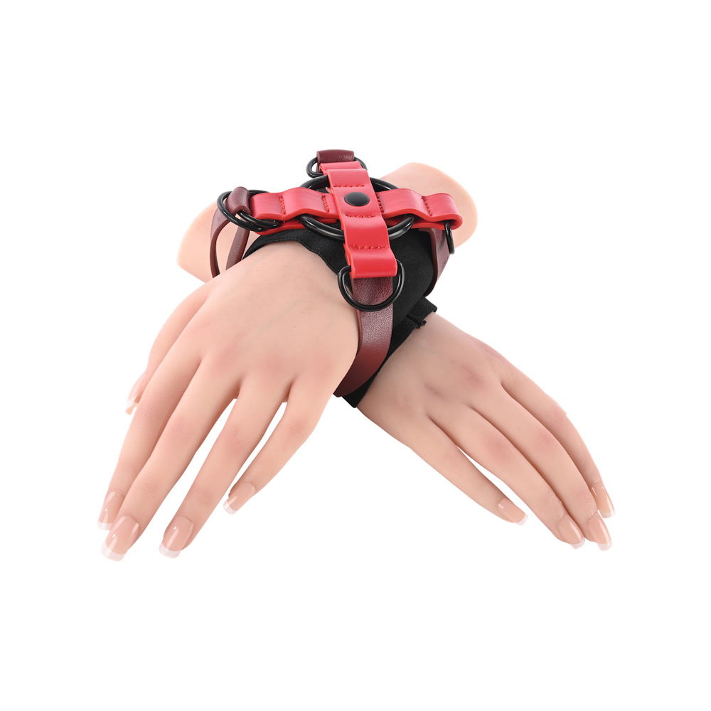 Sportsheets Exs & Ohs Cross Cuffs, an X-shaped wrist restraint with adjustable straps and D-ring fastening
